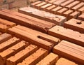 Stacks of reddish-orange clay bricks are arranged in rows Royalty Free Stock Photo
