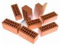 A collection of red clay bricks, each rectangular with perforations, is spread out on a white surface Royalty Free Stock Photo