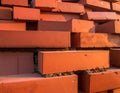 A close-up view of red clay bricks stacked in an interlocking pattern Royalty Free Stock Photo