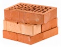 Three stacked bricks are shown. The top brick is perforated with a series of rectangular holes Royalty Free Stock Photo