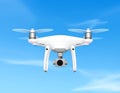 Quadcopter drone with a sleek white body and four propellers hovering against a clear blue sky Royalty Free Stock Photo