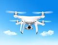 Quadcopter drone in flight against a clear blue sky Royalty Free Stock Photo