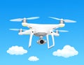 White quadcopter drone with a mounted camera, hovering against a bright blue sky Royalty Free Stock Photo