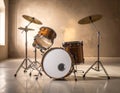 A drum set is arranged in a simple room with light-colored wooden flooring and a textured brown wall Royalty Free Stock Photo