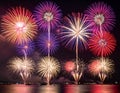 Generated Colorful fireworks explode over a dark sky above a body of water Royalty Free Stock Photo