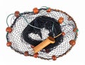 A fishing net with a circular wooden frame and dark mesh is depicted Royalty Free Stock Photo