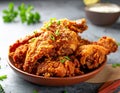A plate of crispy fried chicken drumsticks garnished with sliced green onions Royalty Free Stock Photo