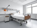 Modern hospital room with a single adjustable bed on wheels Royalty Free Stock Photo