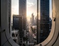 View through a circular window framing a bustling cityscape at sunset in 4k Royalty Free Stock Photo