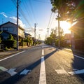 Photo of an empty street in a Japanese suburb, taken on a sunny day at eye level. Royalty Free Stock Photo