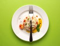 A meal in the center with a fork and a knife crossed under the plate. for colors Royalty Free Stock Photo