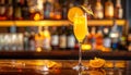 Yellow drink in champagne flut glass at the bar. There is an orange slice Royalty Free Stock Photo