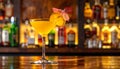 Yellow drink in champagne flut glass at the bar. There is an orange slice Royalty Free Stock Photo