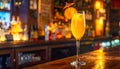 Yellow drink in champagne flut glass at the bar. There is an orange slice Royalty Free Stock Photo
