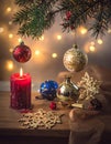 Festive scene with evergreen branches adorned with red and gold ornaments Royalty Free Stock Photo