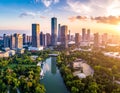 Aerial view of a modern cityscape at sunset, featuring tall skyscrapers reflecting golden light Royalty Free Stock Photo