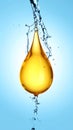 Drop of Omega-3 and water splash on light blue background Royalty Free Stock Photo
