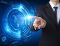 A person in a suit interacts with a digital interface, featuring glowing blue holographic elements Royalty Free Stock Photo