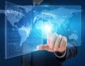 A man in a business suit interacts with a transparent digital interface displaying a world map Royalty Free Stock Photo