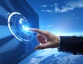 A hand interacts with a futuristic digital interface displaying a globe, suggesting advanced technology Royalty Free Stock Photo