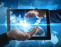 A digital-themed image showing two hands framing a glowing holographic globe, emerging from a tablet screen Royalty Free Stock Photo