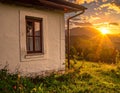 A rustic white cottage features a small window with wooden frames Royalty Free Stock Photo