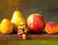 A wooden surface holds a selection of fruits Royalty Free Stock Photo