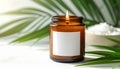 9 oz amber candle jar with wick lit with large white blank square label with no borde Royalty Free Stock Photo