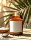 9 oz amber candle jar with wick lit with large white blank square label with no borde Royalty Free Stock Photo