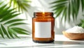 9 oz amber candle jar with wick lit with large white blank square label with no borde Royalty Free Stock Photo