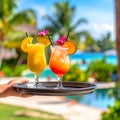 Generates the image of a hand holding a tray with tropical drinks and the hotel backg Royalty Free Stock Photo