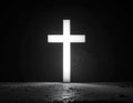A glowing white cross stands against a dark background Royalty Free Stock Photo
