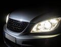 Close-up of a car\'s front end in a dark setting Royalty Free Stock Photo