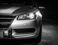 Close-up black and white image of a car\'s front end at night Royalty Free Stock Photo