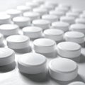 Rows of white, round tablets positioned closely together on a reflective surface Royalty Free Stock Photo