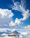 Dramatic cloud formations stretch across a vivid blue sky, with large, fluffy cumulus clouds Royalty Free Stock Photo