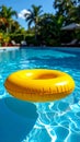 Yellow pool float, floating ring in a refreshing blue swimming pool. Royalty Free Stock Photo