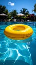 Yellow pool float, floating ring in a refreshing blue swimming pool. Royalty Free Stock Photo