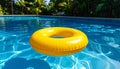 Yellow pool float, floating ring in a refreshing blue swimming pool. Royalty Free Stock Photo