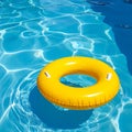 Yellow pool float, floating ring in a refreshing blue swimming pool. Royalty Free Stock Photo