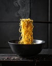 Dark background with golden noodles hovering in the air faithfully ripple Royalty Free Stock Photo