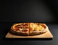 Brutalist product photo of pizza after before one pices on cutting board low light Royalty Free Stock Photo