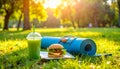 A rolled up yoga mat in the park. A jump rope next to it. In the foreground a delicios Royalty Free Stock Photo