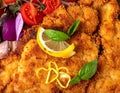 Delicious Breaded Cutlets with Lemon and Tomatoes Royalty Free Stock Photo