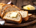 Fresh Bread Slices with Butter on Wooden Board Royalty Free Stock Photo