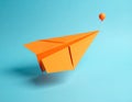 Minimal balloon 3D image of simple hand made paper airplane, made with orange paper Royalty Free Stock Photo