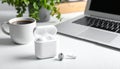 Modern wireless earphones and laptop on light table Royalty Free Stock Photo
