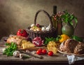Assorted food items on a rustic wooden table include a wicker basket filled with onions and garlic Royalty Free Stock Photo