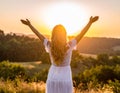 Happy woman on sunset in nature iwith open hands. Happy woman on the sunset in nature Royalty Free Stock Photo