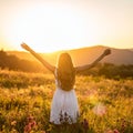 Happy woman on sunset in nature iwith open hands. Happy woman on the sunset in nature Royalty Free Stock Photo